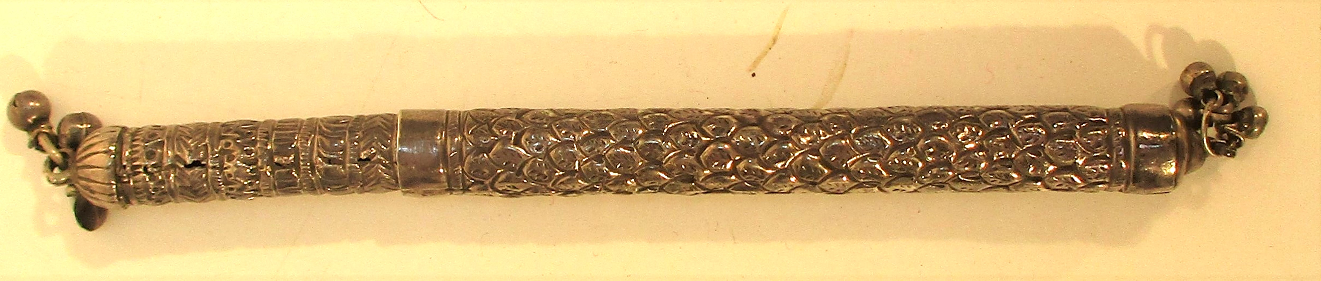 A scribes quill holder. Engraved with tiny bells on the ends. 18cm. long