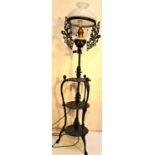 A standard lamp, also Dutch colonial. Three tiers of useful shelves. Cast iron with original glass