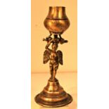 Brass oil lamp from Nepal with an cherub holding the oil container. 25 x 10cm. Late 20th C.