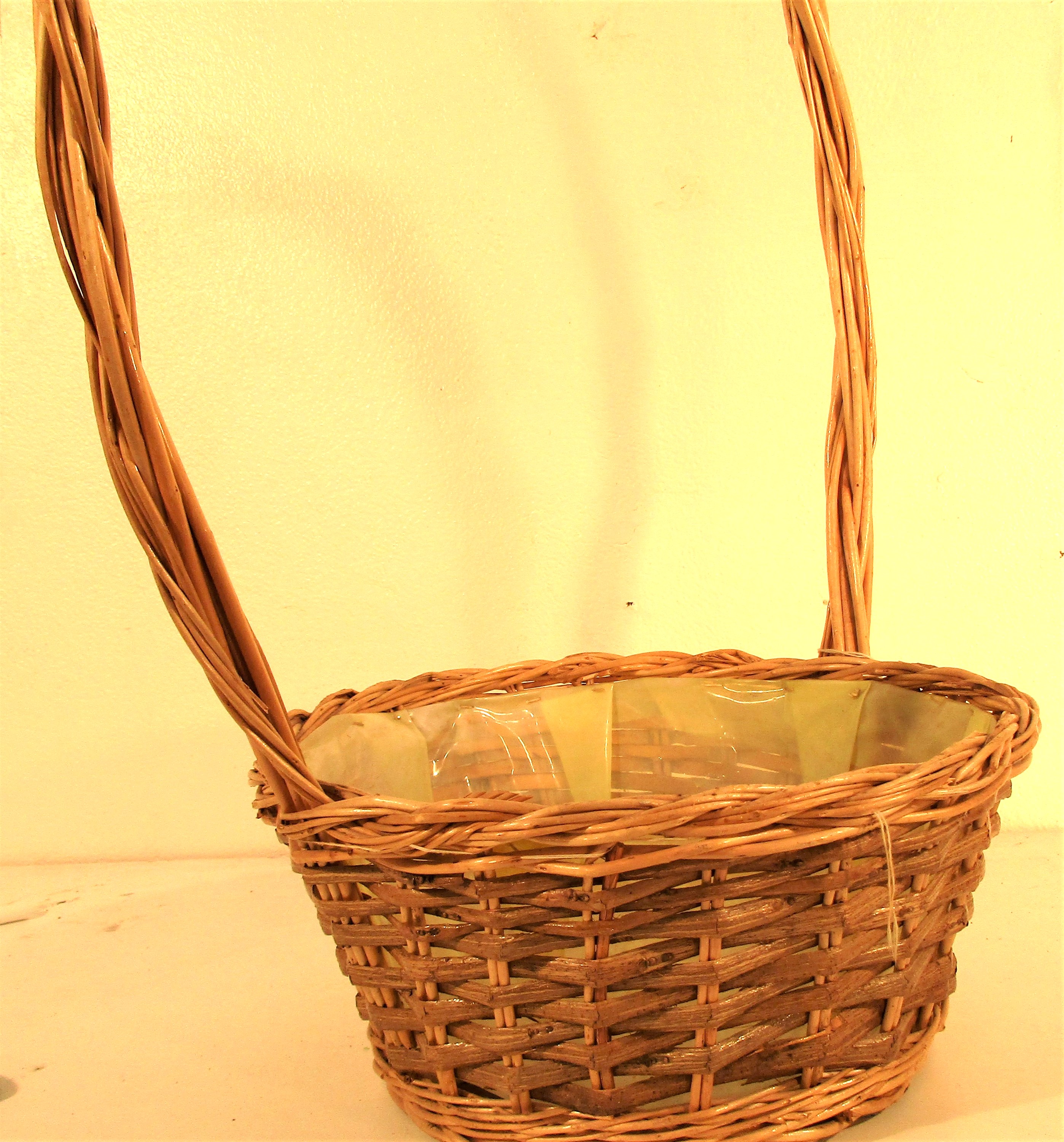 Basket with long handle, lined with plastic. 30 x 60cm.