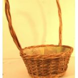 Basket with long handle, lined with plastic. 30 x 60cm.