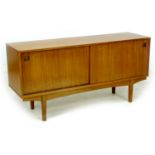 A retro teak sideboard, circa 1960's, with two sliding doors enclosing shelves, 152.5 by 43 by 74.