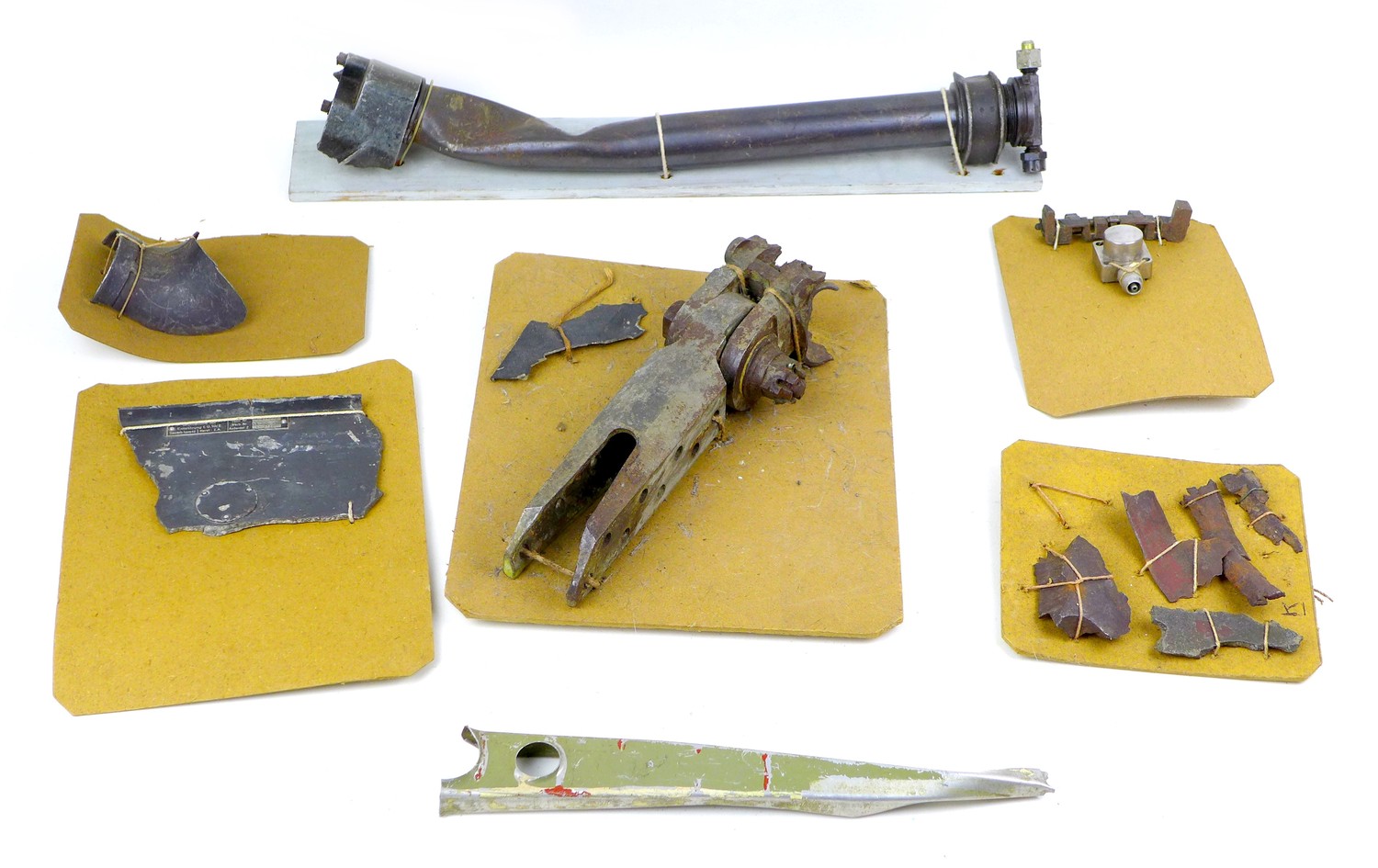 A collection of WWII aircraft relics, including what is purported to be a wing fixing from a