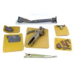 A collection of WWII aircraft relics, including what is purported to be a wing fixing from a