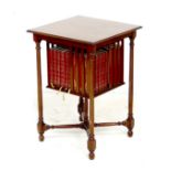 A mahogany side table with revolving bookcase below, the square surface with moulded edge, raised on