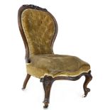 A Victorian button back nursing chair, with walnut carved top-rail, upholstered in olive velvet,