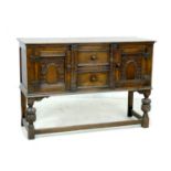 An Old Charm dark stained sideboard, with carved decoration, two central drawers flanked by two