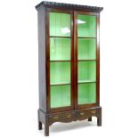 A 20th century mahogany display cabinet, with double glazed doors, above a two drawer base with