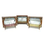 A group of three retro glazed display cabinets, circa 1950's, each with sliding doors and glass