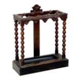 A late Victorian carved oak umbrella stand, with bobbin turned supports and removable drip tray,