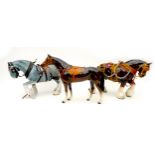 A group of three china animal figurines, comprising two modelled as shire horses, and one as a