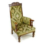 A Victorian oak show frame armchair, with green upholstered back, armrests, and seat, 67 by 81 by