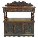 A late Victorian oak buffet, with carved decoration, upper tier with drawers, lower section with