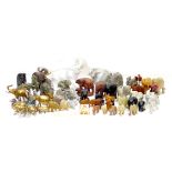 A large collection of over sixty pachyderm figurines, including a white ceramic elephant with