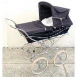 A mid 20th century Silver Cross pram in navy blue with white wheels, 116 by 60 by 98cm high