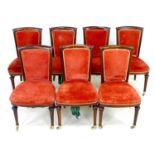 A set of seven Victorian dining chairs, with scroll backs, turned front legs, raised on brass