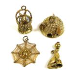 A collection of four gold charms or pendants, one in the form of a beehive, two bees applied to