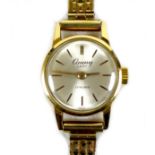 A Cauny Lady 18ct gold lady's wristwatch, circa 1980, circular silvered dial with gold batons, 17