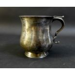 A George V silver half pint tankard of baluster form, with scroll handle, with rubbed maker's marks,