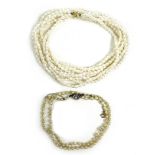 Two pearl necklaces, one a 19th century example with yellow metal clasp inset with grey seed pearls,