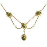 An Edwardian 15ct gold, seed pearl and green stone festoon necklace, 9.2g.