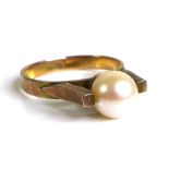 A 14ct gold ring set with pearl surrounded by unusual arching shoulder setting, marked 14k to