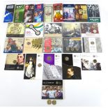 A collection of twenty-five Royal Mint £2 commemorative coin sets and two loose £2 coins,