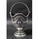 A George V Irish silver pedestal basket dish, with undulating rim and bead border, plain hinged