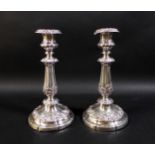 A pair of 19th century Continental white metal candlesticks, the knopped reeded columns clasped with