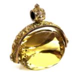 A large 9ct gold and citrine swivel fob, prism form with faceted edges, scrolling foliate mount