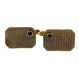 A pair of 9ct gold engine turned cuff links, the rectangular faces inset with small blue stones,