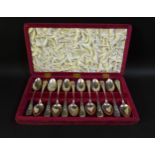A cased set of American early 20th century silver teaspoons, with bright cut decorated handles,
