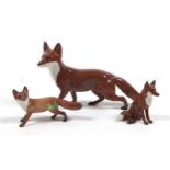 Three Beswick fox figurines, comprising 'Fox- standing', model 1440, red-brown and white - gloss,