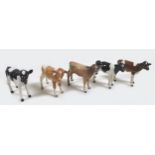 A group of five Beswick calves, including two Friesian calves, model 1249C, black and white - gloss,