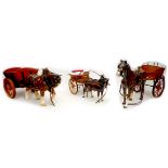 A group of three Melba Ware ceramic horses, each pulling a wooden cart. (6)