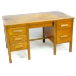 A 1940s oak desk, by Partridge & Cooper, London, of twin pedestal design with six drawers, 137 by