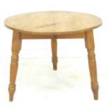 A pine cricket table, 20th century, the circular surface raised on three turned legs, 92.5 by 92.5