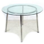 A 20th century IKEA glass topped circular table, with chrome legs, 105 by 105 by 73cm high.