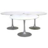 Three Arkana tulip tables with circular tops, 106 by 106 by 72cm high. (3) Provenance - From