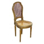 A French early 20th century giltwood carved side chair, with caned seat and back, stamped to