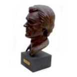 Doreen Kern (British, 1931-2021): Clint Eastwood resin bust, signed and dated '77', raised upon