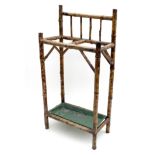 A Edwardian bamboo stick stand, two division, with green metal drip tray, 43 by 23 by 88cm high.