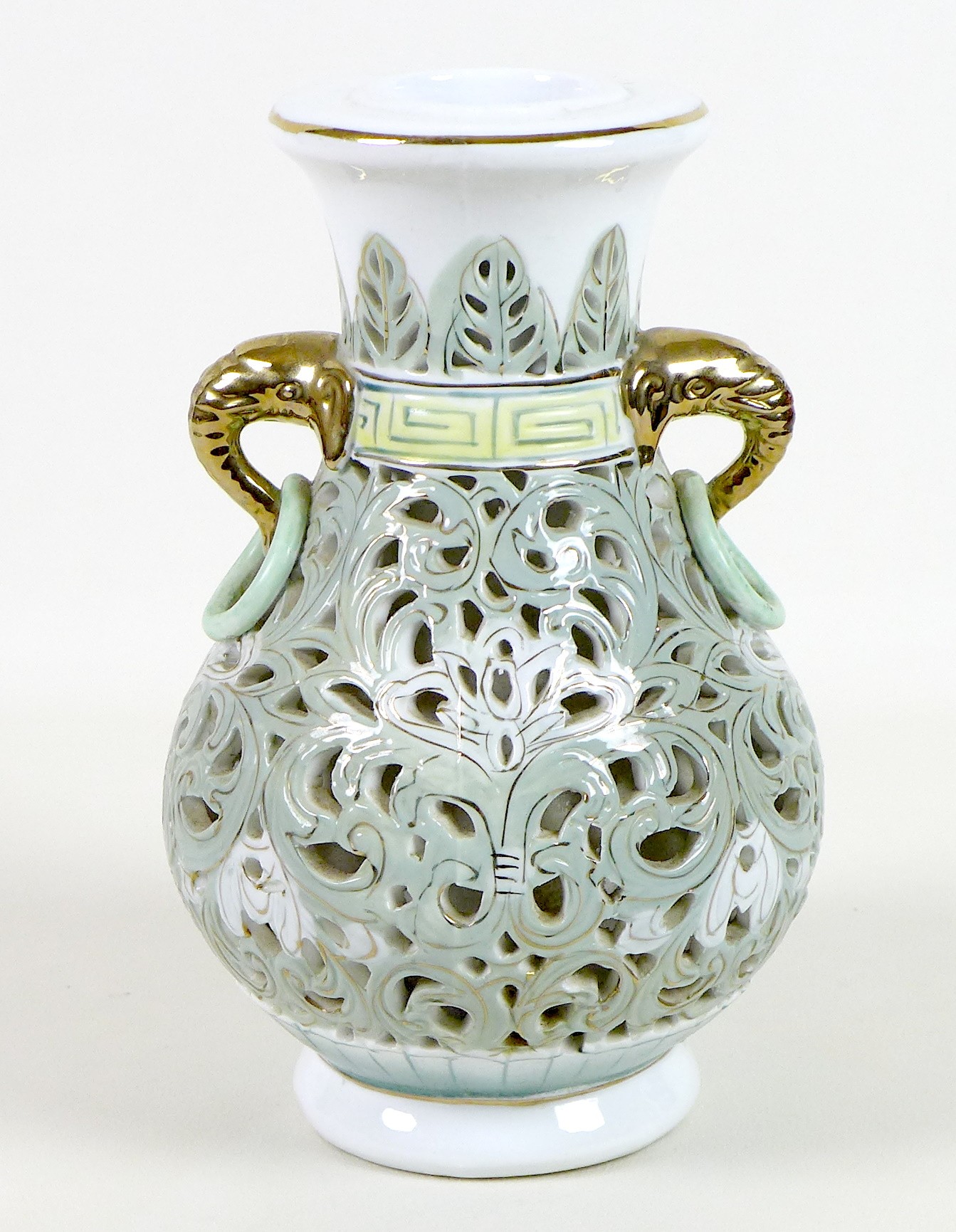 A modern Chinese porcelain reticulated vase, of baluster form with gilt highlighted elephant head