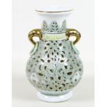 A modern Chinese porcelain reticulated vase, of baluster form with gilt highlighted elephant head