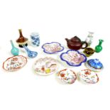 A collection of miniature Chinese pottery and porcelain items, including a Yixing pottery teapot and