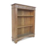 A Victorian oak bookcase, with relief carved panels, two adjustable shelves, 92 by 29 by 117cm high.
