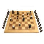 A modern brass chess set, the turned bodies with black and white plastic tops, king 9cm high,