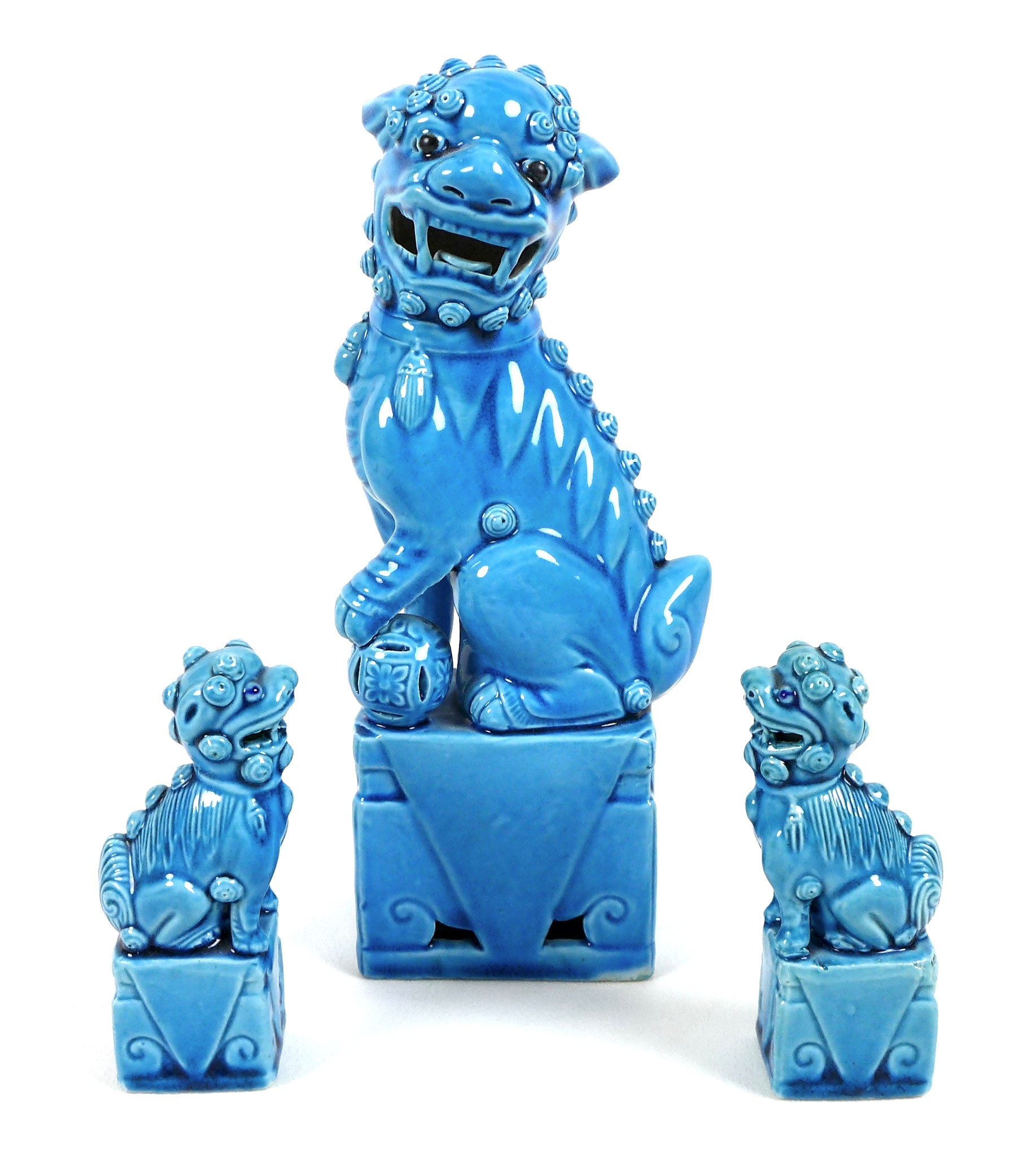 A modern Chinese turquoise glazed figure of a Buddhistic lion dog, modelled seated with left forepaw