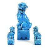 A modern Chinese turquoise glazed figure of a Buddhistic lion dog, modelled seated with left forepaw