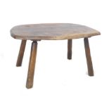 A mid 20th century oak side table, circa 1960, with organically shaped surface raised on four